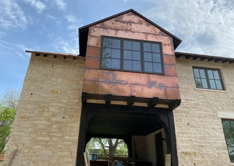 Copper metal panel facade on a stone building for Skylight Installation in Willard